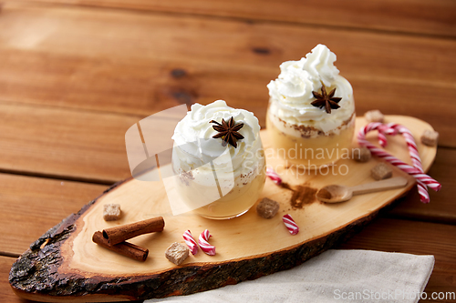 Image of glasses of eggnog with whipped cream and anise