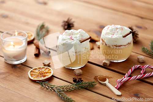 Image of glasses of eggnog with whipped cream and spices