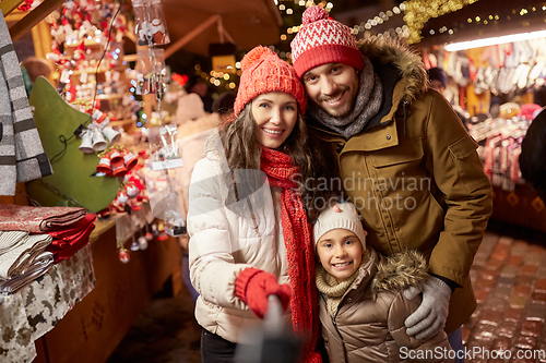 Image of happy family taking selfie at christmas market