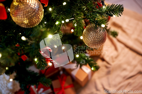 Image of decorated artificial christmas tree at home