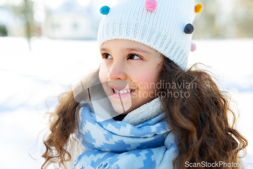 Image of happy little girl in winter clothes outdoors