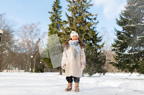 Image of happy little girl in winter clothes outdoors