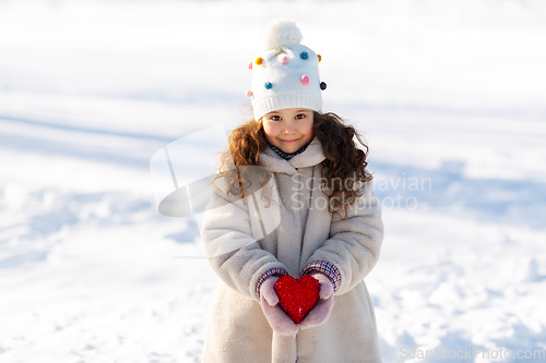 Image of happy little girl with heart outdoors in winter