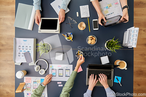 Image of business team with gadgets working at office table