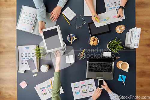 Image of business team with gadgets working at office table