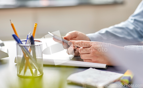 Image of close up of woman with using smartphone at office