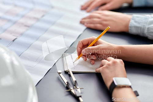 Image of architect with notebook working at office