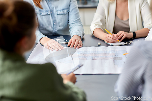 Image of business team with blueprint working at office