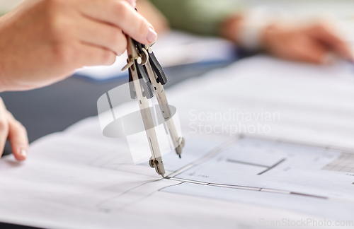 Image of architect with blueprint and drafting compass