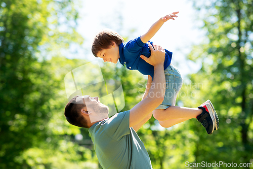 Image of happy father with son playing in summer park