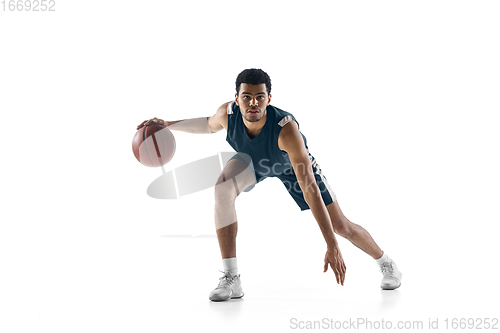 Image of Young arabian basketball player of team in action, motion isolated on white background. Concept of sport, movement, energy and dynamic.