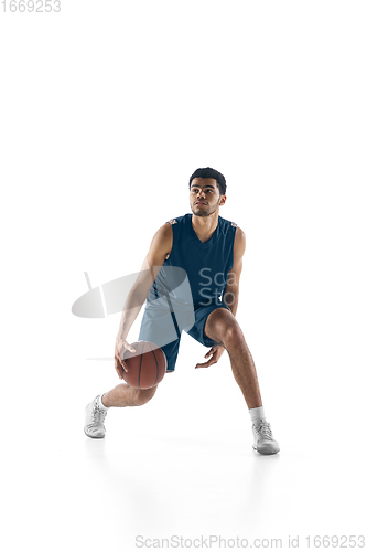 Image of Young arabian basketball player of team in action, motion isolated on white background. Concept of sport, movement, energy and dynamic.