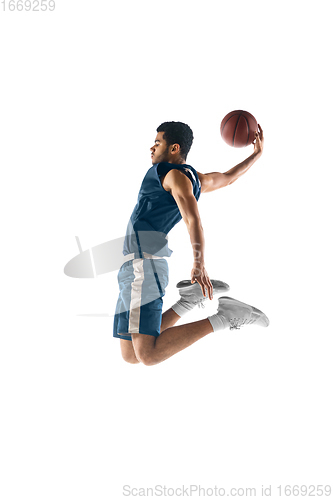 Image of Young arabian basketball player of team in action, motion isolated on white background. Concept of sport, movement, energy and dynamic.