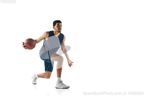 Image of Young arabian basketball player of team in action, motion isolated on white background. Concept of sport, movement, energy and dynamic.