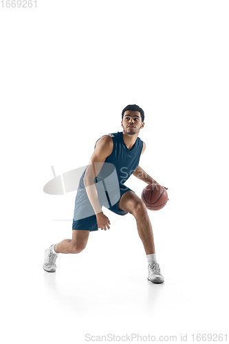 Image of Young arabian basketball player of team in action, motion isolated on white background. Concept of sport, movement, energy and dynamic.