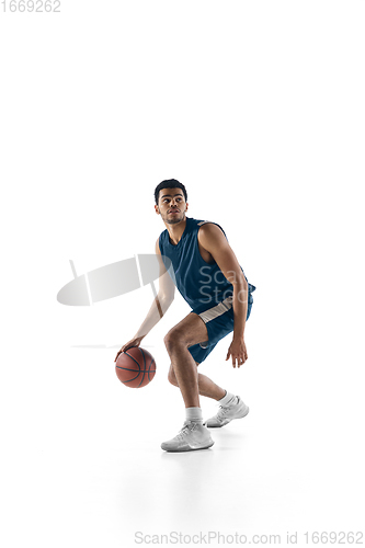 Image of Young arabian basketball player of team in action, motion isolated on white background. Concept of sport, movement, energy and dynamic.