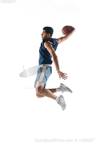 Image of Young arabian basketball player of team in action, motion isolated on white background. Concept of sport, movement, energy and dynamic.