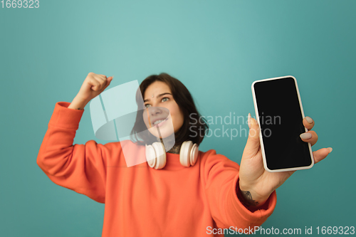 Image of Caucasian woman\'s portrait isolated on blue studio background with copyspace