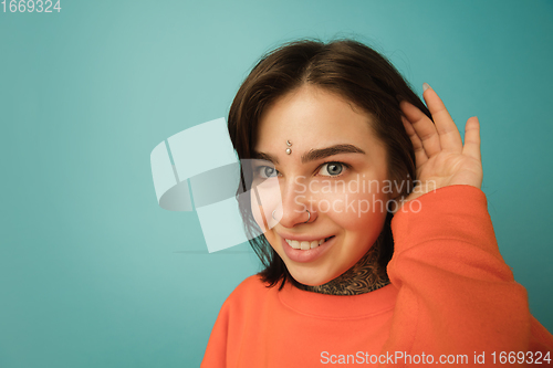 Image of Caucasian woman\'s portrait isolated on blue studio background with copyspace