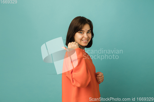 Image of Caucasian woman\'s portrait isolated on blue studio background with copyspace