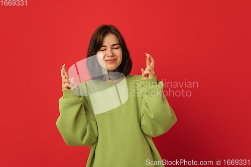 Image of Caucasian woman\'s portrait isolated on red studio background with copyspace