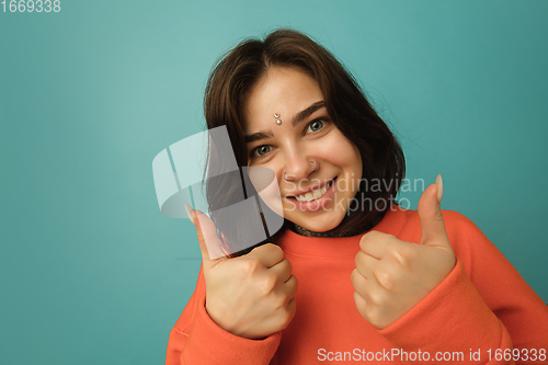 Image of Caucasian woman\'s portrait isolated on blue studio background with copyspace