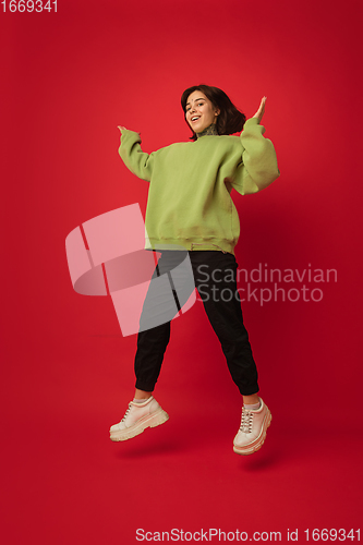 Image of Caucasian woman\'s portrait isolated on red studio background with copyspace