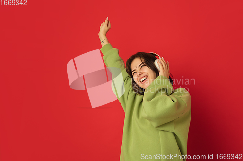 Image of Caucasian woman\'s portrait isolated on red studio background with copyspace