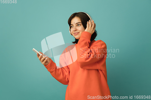 Image of Caucasian woman\'s portrait isolated on blue studio background with copyspace