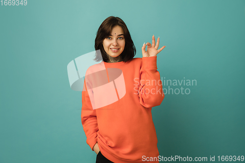 Image of Caucasian woman\'s portrait isolated on blue studio background with copyspace