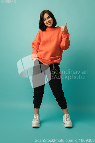 Image of Caucasian woman\'s portrait isolated on blue studio background with copyspace