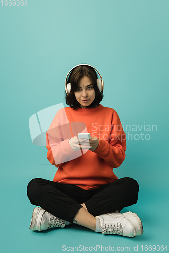 Image of Caucasian woman\'s portrait isolated on blue studio background with copyspace