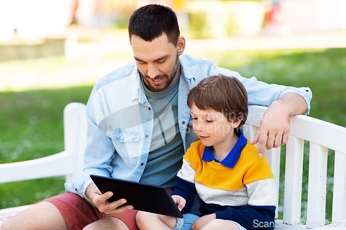 Image of father and son with tablet pc computer at park