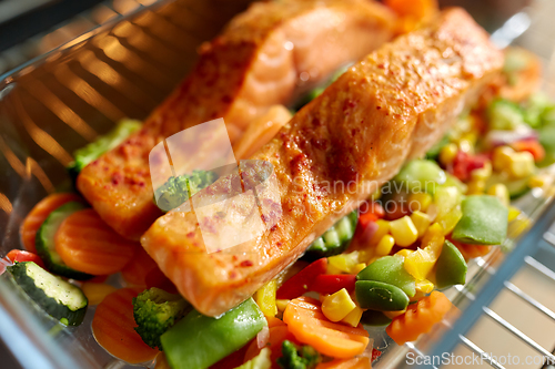 Image of food cooking in baking dish in oven at home