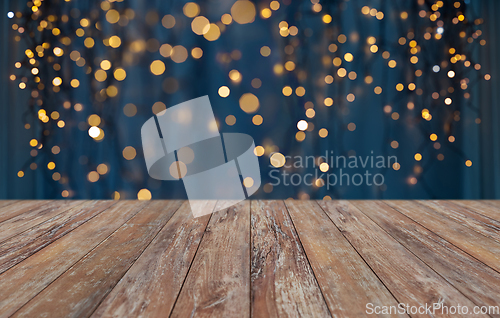 Image of empty wooden table with christmas golden lights