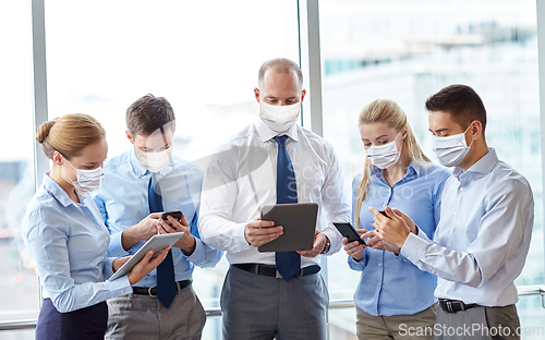 Image of business people in masks with tablet pc and phones