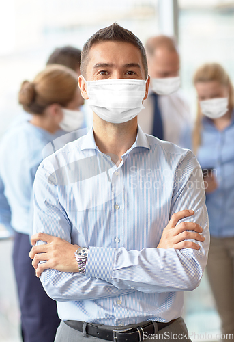 Image of businessman wearing face protective mask at office