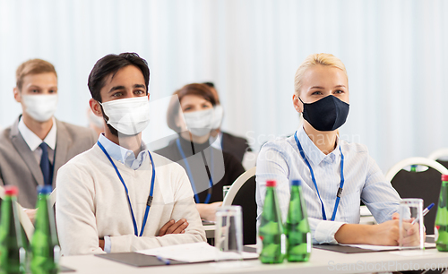 Image of business people in masks at worldwide conference