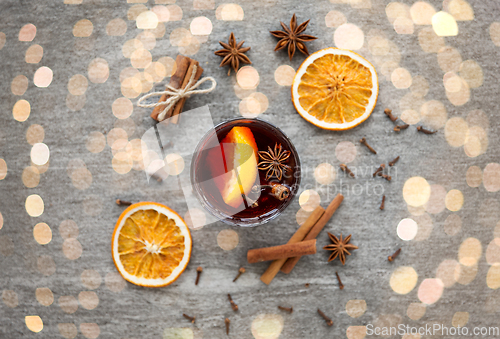 Image of hot mulled wine, orange slices, raisins and spices