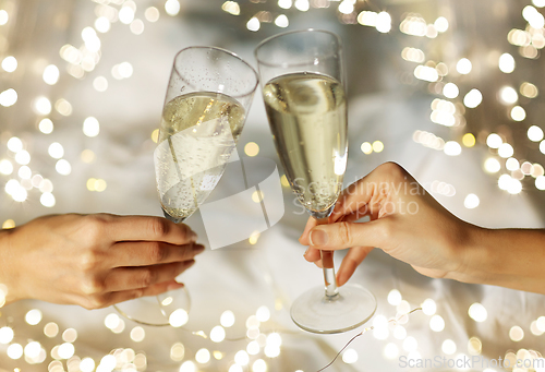 Image of close up of lesbian couple with champagne glasses