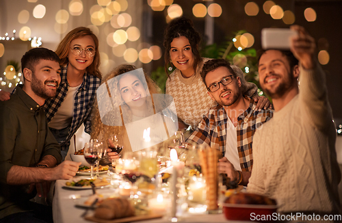 Image of friends taking selfie at christmas dinner party