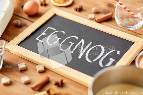 Image of eggnog word on chalkboard, ingredients and spices