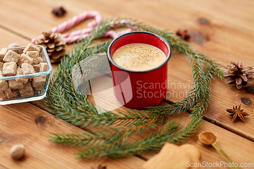 Image of cup of eggnog, fir branches, gingerbread and sugar