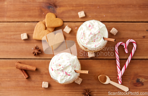 Image of glasses of eggnog with whipped cream and cinnamon