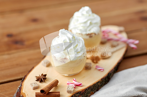 Image of glasses of eggnog with whipped cream and anise