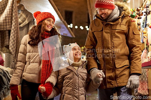 Image of happy family at christmas market in city