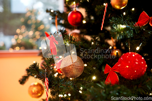 Image of decorated artificial christmas tree at home