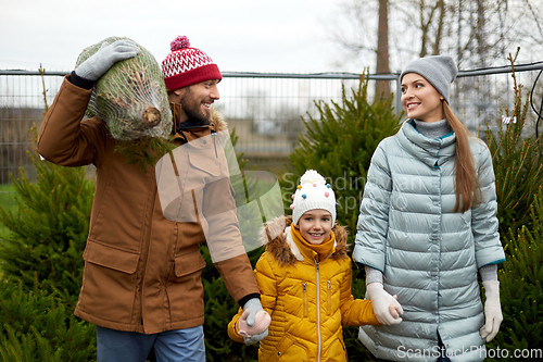 Image of happy family buying christmas tree at market