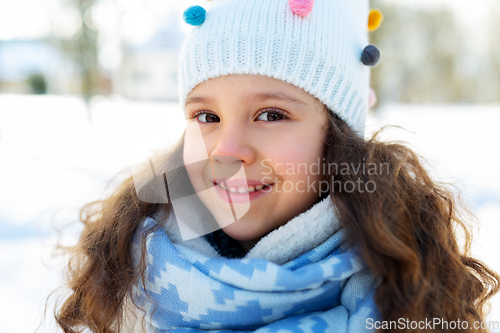 Image of happy little girl in winter clothes outdoors