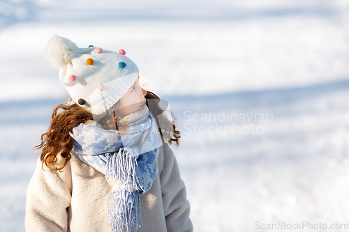 Image of little girl in winter clothes outdoors